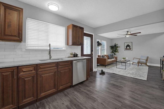 kitchen with sink, dishwasher, tasteful backsplash, light stone countertops, and dark hardwood / wood-style flooring