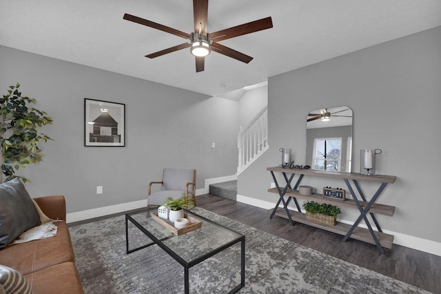 living room featuring ceiling fan and dark hardwood / wood-style floors