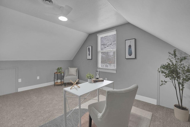 carpeted office featuring ceiling fan, lofted ceiling, and a textured ceiling