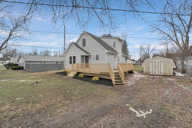 rear view of house featuring a shed, a wooden deck, and a lawn