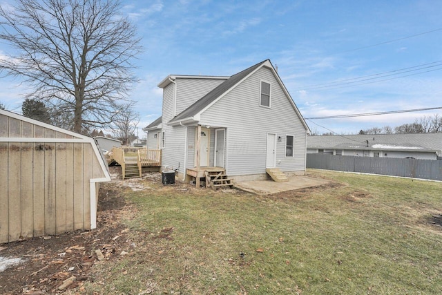 back of property with central AC, a deck, and a lawn