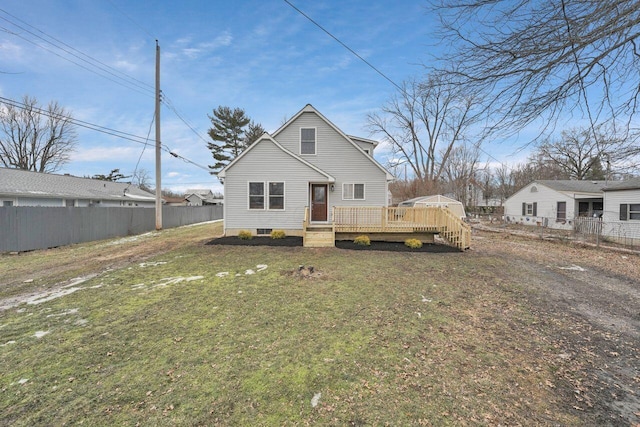 back of house featuring a yard and a deck