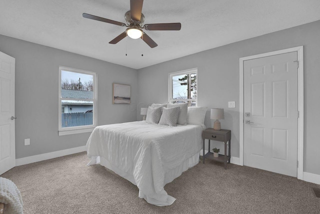 bedroom featuring ceiling fan, carpet flooring, and a textured ceiling