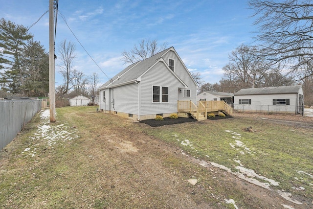 view of home's exterior with a wooden deck and a yard