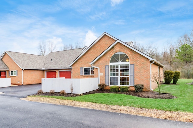 view of front of home with a garage and a front lawn