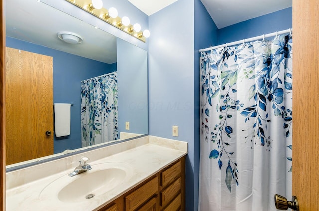 bathroom with vanity and curtained shower