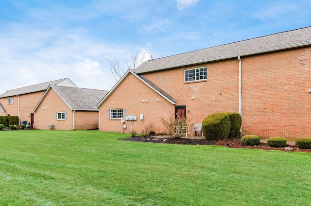 rear view of house with a lawn