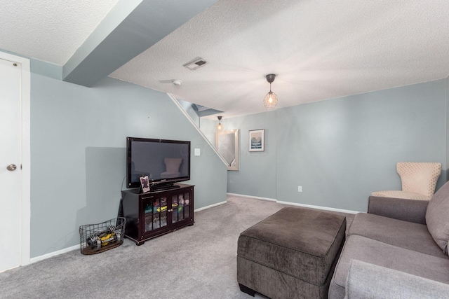 carpeted living room with a textured ceiling