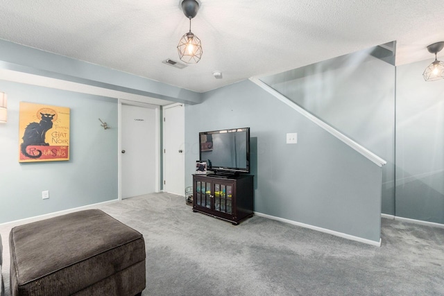 living room featuring carpet flooring and a textured ceiling