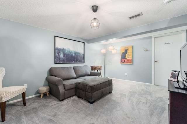 living room featuring carpet floors and a textured ceiling