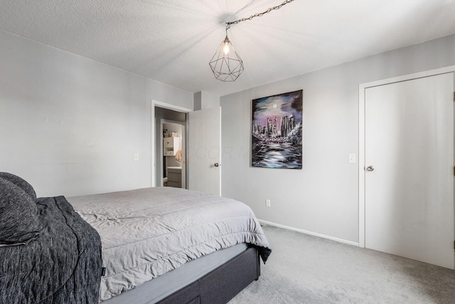 bedroom with a textured ceiling and carpet