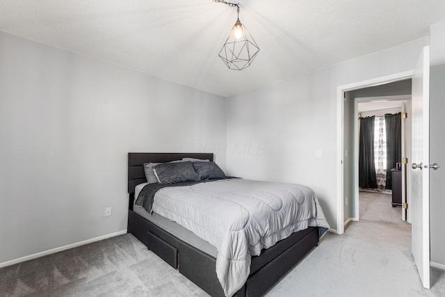 carpeted bedroom featuring a textured ceiling