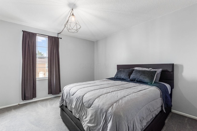 carpeted bedroom with a textured ceiling