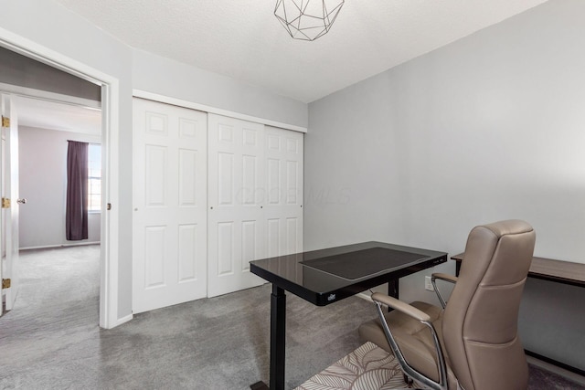 home office with carpet and a textured ceiling