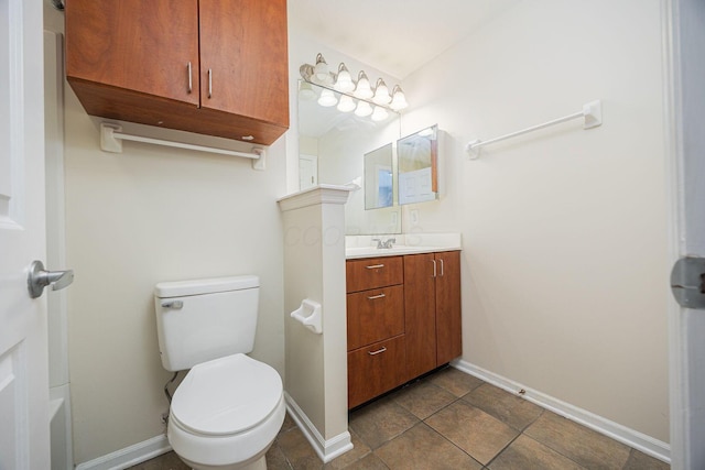 bathroom featuring tile patterned flooring, vanity, and toilet