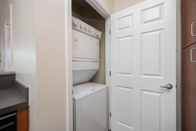 laundry area featuring stacked washer / drying machine