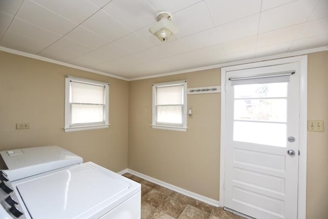 laundry area with separate washer and dryer and crown molding