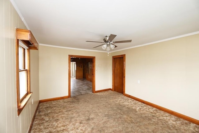 unfurnished room with crown molding, carpet flooring, and ceiling fan