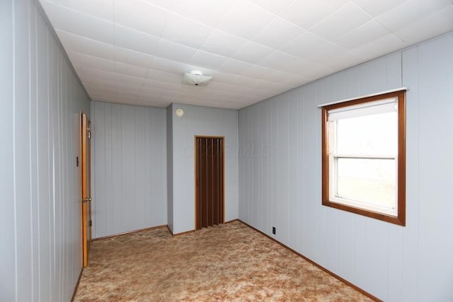 unfurnished room featuring light carpet