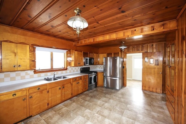 kitchen with sink, decorative light fixtures, wooden ceiling, and appliances with stainless steel finishes