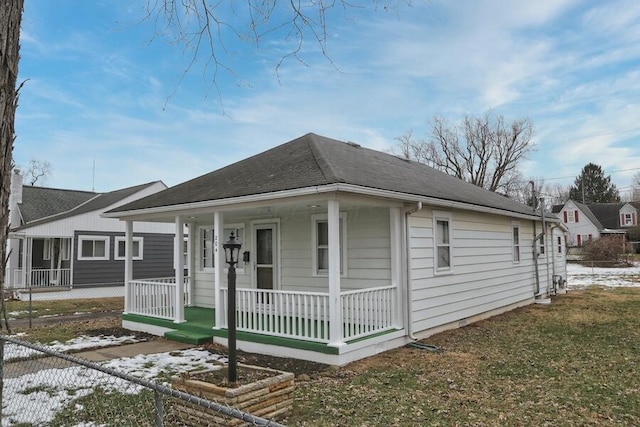 bungalow with a porch and a lawn