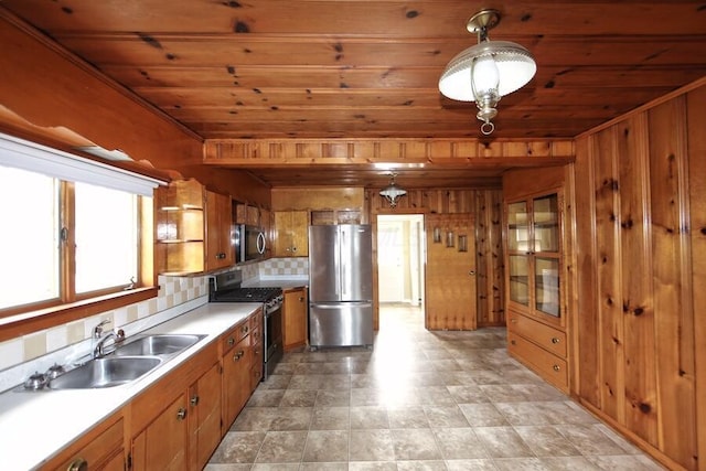 kitchen featuring appliances with stainless steel finishes, sink, wooden ceiling, and decorative light fixtures