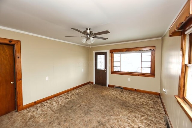 carpeted empty room featuring ornamental molding and ceiling fan