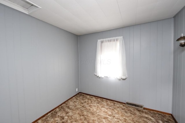 spare room featuring light carpet