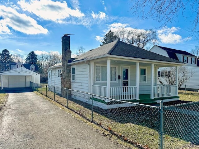 bungalow-style house with an outbuilding, a garage, and a porch