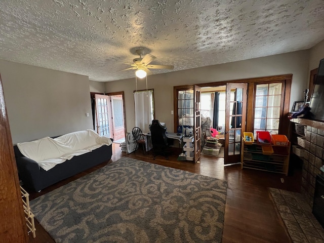 bedroom featuring ceiling fan, dark wood-type flooring, and a textured ceiling