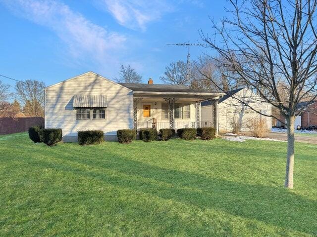 ranch-style home with a porch and a front lawn