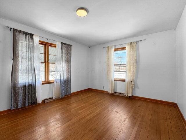 unfurnished room with hardwood / wood-style floors