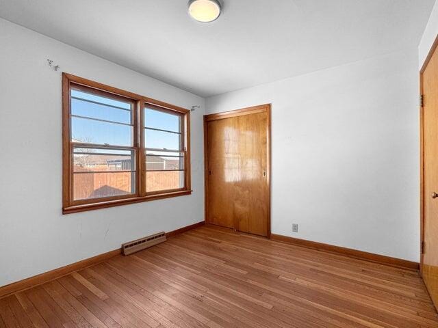 empty room with hardwood / wood-style flooring