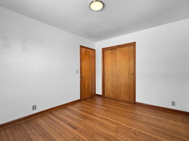 unfurnished room featuring hardwood / wood-style flooring