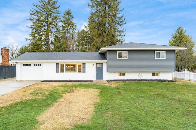 split level home featuring a garage and a front yard