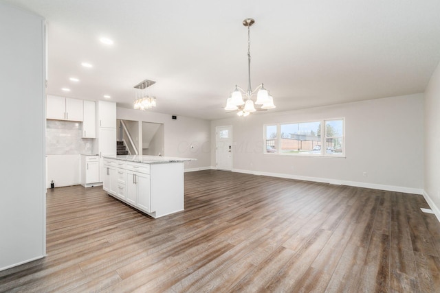 kitchen with hanging light fixtures, white cabinets, a chandelier, and light hardwood / wood-style floors