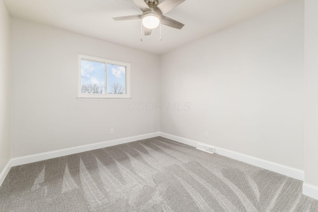 empty room featuring carpet floors and ceiling fan