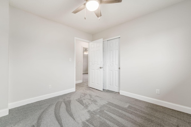 unfurnished bedroom with carpet floors, ceiling fan, and a closet