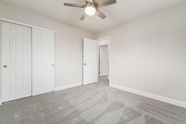 unfurnished bedroom with carpet flooring, ceiling fan, and a closet