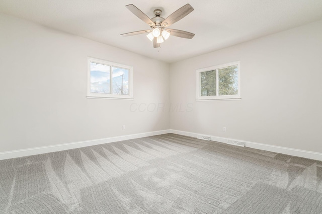 carpeted spare room with ceiling fan