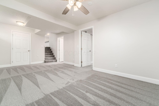 basement featuring carpet and ceiling fan