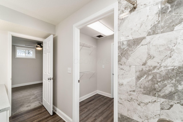 bathroom featuring hardwood / wood-style flooring and ceiling fan