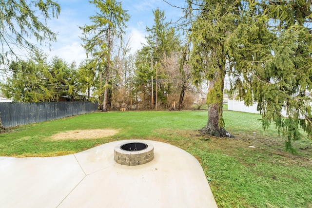 view of yard with a patio and an outdoor fire pit