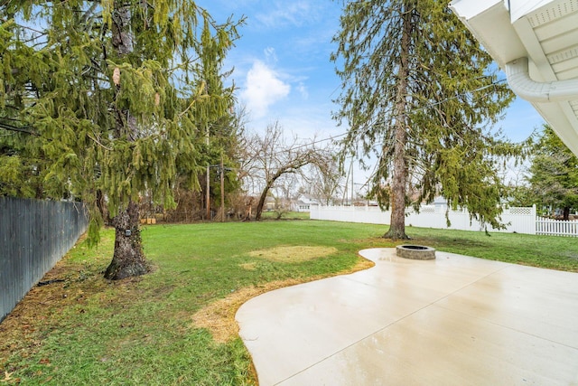 view of yard with a fire pit and a patio