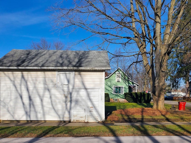 view of home's exterior featuring an outbuilding and a garage