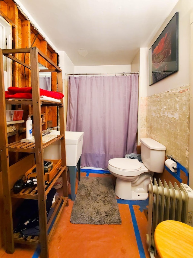 bathroom featuring walk in shower, toilet, concrete floors, tile walls, and radiator heating unit