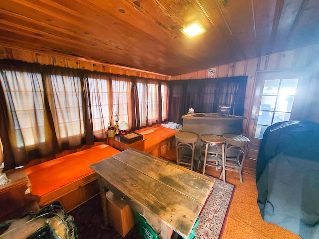 dining space with a wealth of natural light and wooden ceiling