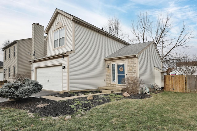 view of front of house featuring a garage and a front yard