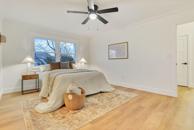 bedroom featuring crown molding, ceiling fan, and light hardwood / wood-style flooring