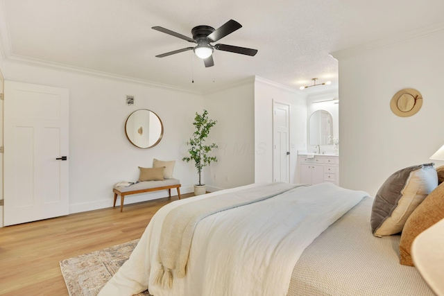 bedroom featuring ensuite bath, wood-type flooring, ornamental molding, and ceiling fan